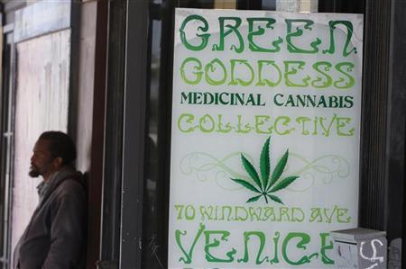 A man stands in front of a medical marijuana dispensary in Los Angeles, California, July 24, 2012. REUTERS/Jonathan Alcorn