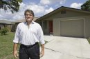 In this Sept. 12, 2012, photo, Andrew Neitlich poses in front of one his investment homes in Venice, Fla. Neitlich once worked as a financial analyst picking stocks for a mutual fund. During the dot-com crash 12 years ago, Neitlich didn't sell his stocks, but like many others he is selling now. An analysis by The Associated Press finds that individual investors have pulled at least $380 billion from U.S. stock funds since they started selling in April 2007. (AP Photo/Chris O'Meara)