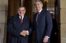 Defense Secretary Leon Panetta, left, and British Defense Minister Philip Hammond, shake hands for photographers before their meeting at Lancaster House in London, Saturday, Jan. 19, 2013, on the last day of Panetta's final overseas trip. (AP Photo/Jacquelyn Martin)