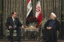 In this photo released by the official website of the office of the Iranian Presidency, Iran's President Hassan Rouhani, right, meets with Iraqi Prime Minister Nouri al-Maliki in Tehran, Iran, Thursday, Dec. 5, 2013. (AP Photo/Iranian Presidency Office, Mohammad Berno)