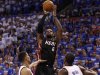 Miami Heat's James shoots over Oklahoma City Thunder's Sefolosha and Ibaka in the fourth quarter during Game 2 of the NBA basketball finals in Oklahoma City