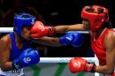 Kiribati's Taoriba Biniati, left, fights Mauiritius Isabelle Ratna in the women's light 57-60 kg boxing bout during the 2014 Commonwealth Games in Glasgow, Scotland, Tuesday July 29, 2014. (AP Photo/PA, Peter Byrne) UNITED KINGDOM OUT NO SALES NO ARCHIVE