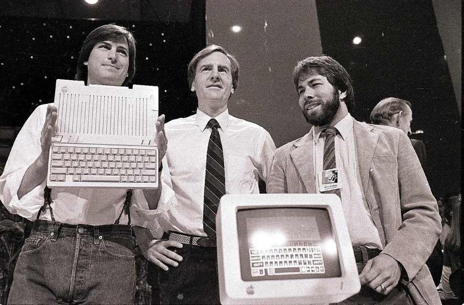1984 - From left, Steve Jobs, chairman of Apple Computers, John Sculley, president and CEO, and Steve Wozniak, co-founder of Apple, unveil the new Apple IIc computer in San Francisco. Apple on Wednesd