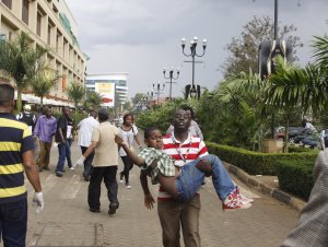 A rescue worker helps a child outside the Westgate …