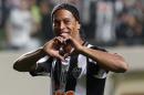 FILE - In this July 11, 2013 file photo, Brazil's Atletico Mineiro's Ronaldinho celebrates his team's victory over Argentina's Newell's Old Boys at the end of a Copa Libertadores semifinal soccer match in Belo Horizonte, Brazil. The Brazilian soccer midfielder is putting his Rio de Janeiro mansion on the rental market during the last half of the World Cup. The real estate agency handling the property says on its website that the five-bedroom house is available for the first 15 days of July for $15,522 a day. (AP Photo/Bruno Magalhaes, File)