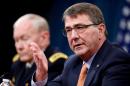 Defense Secretary Ash Carter, right, accompanied by Joint Chiefs Gen. Martin Dempsey, speaks during a news conference at the Pentagon, Thursday, April 16, 2015. (AP Photo/Andrew Harnik)