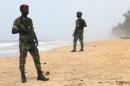 Soldiers stand guard on the beach following an attack by gunmen from al Qaeda's North African, in Grand Bassam, Ivory Coast