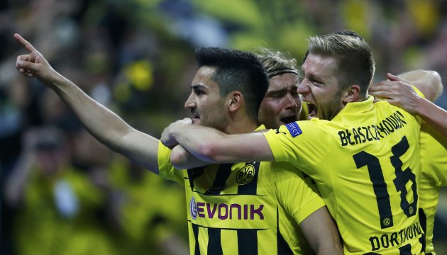 Borussia Dortmund's Ilkay Guendogan is mobbed by team mates after scoring a penalty during their Champions League Final soccer match against Bayern Munich at Wembley Stadium in London