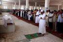 Friends and relatives pray over body of Abdelbaset Ali Mohmedal-Megrahi, the only person convicted over the 1988 Lockerbie bombing which killed 270 people, during his funeral on May 21, 2012 in Janzur, a suburb West of the Libyan capital