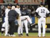 New York Yankees shortstop Jeter is carried off the field by trainer Donohue and manager Girardi after injuring himself while playing against the Detroit Tigers during the 12th inning of Game 1 of their MLB ALCS playoff baseball series in New York