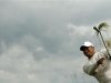 Tiger Woods of the U.S. hits from the rough during the first round of the British Open golf championship at Royal Lytham & St Annes