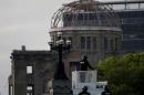 Japanese riot police guard in front of the Atomic Bomb Dome at the Peace Memorial Park in Hiroshima