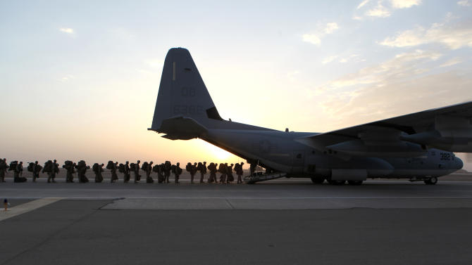 This handout photo provided Defense Department shows Marines and sailors with Marine Expeditionary Brigade – Afghanistan load onto a KC-130 aircraft on the Camp Bastion, Afghanistan flightline, Monday, Oct. 27, 2014. The handover of the U.S. Marines' main base to Afghan control in the hardscrabble Helmand province is more than a signal that America’s longest war is ending. It is a reminder of the enormous loss and sacrifice by Marines who swept in as part of President Barack Obama’s surge of forces against a resurgent Taliban in 2009. (AP Photo/Staff Sgt. John Jackson, Defense Department, US Marines)