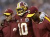 Washington Redskins quarterback Robert Griffin III is helped off the filed after an injury during the second half of an NFL football game against the Baltimore Ravens in Landover, Md., Sunday, Dec. 9, 2012. (AP Photo/Patrick Semansky)