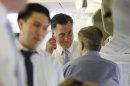 Republican presidential candidate and former Massachusetts Gov. Mitt Romney talks to strategist Stuart Stevens, right, as adviser Lanhee Chen is seen at left as they board their charter plane in Tel Aviv, Israel as they travel to Poland, Monday, July 30, 2012. (AP Photo/Charles Dharapak)