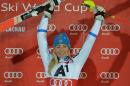 Sweden's winner Frida Hansdotter celebrates on the podium after the final run of an alpine ski women's World Cup slalom in Flachau, Austria, on Tuesday, Jan. 13, 2015. (AP Photo/Kerstin Joensson)