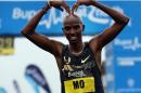 Britain's Mo Farah does his trademark 'Mobot' gesture after finishing second in the Great North Run half marathon in South Shields, near Newcastle in northeast England on September 15, 2013