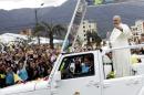 Pope Francis greets the faithful from a popemobile in Quito