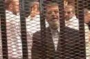 This image made from video provided by Egypt's Interior Ministry shows ousted President Mohammed Morsi speaking from the defendant's cage as he stands with co-defendants in a makeshift courtroom during a trial hearing in Cairo, Egypt, Monday, Nov. 3, 2013. Emerging from four months in secret detention, Egypt's deposed Islamist president defiantly rejected a court's authority to try him Monday, saying he was the country's "legitimate" leader and those that overthrew him should face charges instead.(AP Photo/Egyptian Interior Ministry)