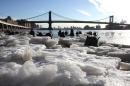 FILE - In this Feb. 16, 2015 file photo, ice forms along the shore of the Manhattan side of the East River in New York where temperatures in the city were in the single digits. For many cities in the Northeast, it was the coldest February on record, and some places recorded the most days of zero or below temperatures. The Manhattan Bridge is in the background. (AP Photo/Peter Morgan, File)