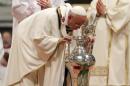 Pope Francis blows on blessed Chrism oil as he celebrates the Chrism Mass in Saint Peter's Basilica at the Vatican