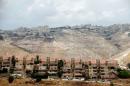 Houses are seen in the West Bank Jewish settlement of Maale Adumim as the Palestinian village of Al-Eizariya is seen in the background