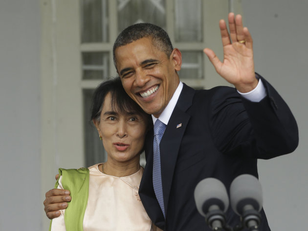 U.S. President Barack Obama, right, waves as he embraces Myanmar democracy activist Aung San Suu Kyi after addressing members of the media at Suu Kyi's residence in Yangon, Myanmar, Monday, Nov. 19, 2012. Obama touched down Monday morning, becoming the first U.S. president to visit the Asian nation also known as Burma. (AP Photo/Pablo Martinez Monsivais)
