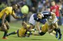 Scotland's Tim Visser, right, is tackled by Australia's players during their rugby union international match at the Murrayfield Stadium, in Edinburgh, Scotland, Saturday Nov. 12, 2016. (Jane Barlow/PA via AP)