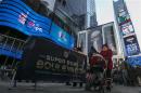 A woman walks through Times Square which has been transformed into Super Bowl Boulevard ahead of Super Bowl XLVIII in New York