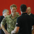 Britain's Prince Harry talks with members of the British Warrior Games Team who relaxed in a gymnasium before the opening of the 2013 Warrior Games, at the U.S. Olympic Training Center, in Colorado Springs, Colo., Saturday May 11, 2013. (AP Photo/Brennan Linsley, Pool)
