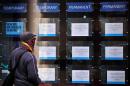 A man looks at job adverts in the window of a job recruitment centre in central London, on January 22, 2014