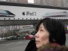 File photo of a woman standing near an Apple billboard advertising the iPad 2 in downtown Shanghai