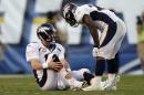Denver Broncos quarterback Peyton Manning, left, holds his leg after being injured while playing the San Diego Chargers as teammate running back Knowshon Moreno, right, talks with him during the second half of a NFL football game on Sunday, Nov. 10, 2013, in San Diego. (AP Photo/Gregory Bull)