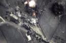 In this photo made from the footage taken from Russian Defense Ministry official web site on Thursday, Oct. 1, 2015 a bomb explosion is seen in Syria. Reacting to criticism that it is targeting opponents of the Syrian government, a spokesman for Russian President Vladimir Putin admitted on Thursday that Russia's airstrikes in Syria are targeting not only Islamic State militants but also other groups. (AP Photo/ Russian Defense Ministry Press Service)