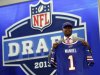 Quarterback E.J. Manuel from Florida State stands with the team jersey after being selected 16th overall by the Buffalo Bills in the first round of the NFL football draft, Thursday, April 25, 2013 at Radio City Music Hall in New York.  (AP Photo/Jason DeCrow)