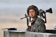 A South Korean soldier stands on a military guard post near the demilitarized zone (DMZ) dividing the two Koreas in the border city of Paju on April 5, 2013