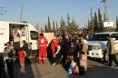 A handout picture released by the official Syrian Arab News Agency (SANA) on October 12, 2013 shows Syrian women and children arriving to be evacuated by Syria's Red Crescent from a Damascus suburb