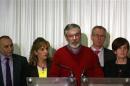 Adams and party colleagues speak to the media in Belfast