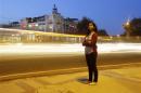 Inayat Naomi Ramdas, 21, poses for a photograph at a busy traffic intersection in New Delhi