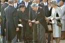 Japanese lawmaker Yamamoto hands a letter to Emperor Akihito during the annual autumn garden party at the Akasaka Palace imperial garden in Tokyo