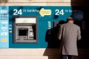 A man use an ATM on March 23 in Nicosia, Cyprus. The government has reached a last-minute bailout deal to rescue the island's failing banks.