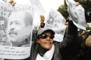 Woman chants slogans and holds pictures of assassinated leftist politician Belaid during demonstration against Islamist Ennahda movement in Tunis