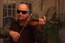 This framegrab image from video, provided by Stefan Avalos, shows soloist Ilya Kaler wearing welder glasses so he can't see the violin during a test of old and new instruments outside Paris in September 2012. Ten world class soloists put old Italian violins, including multi-million dollar Stradivariuses, and newer cheaper ones to a blind scientific test. The results may seem off key to musicians and collectors, but the newer instruments won handily. Contrary to musical convention, a new scientific study found most of the violinists passed up older violins when the lights were dimmed and the musicians had to wear dark glasses. Most of them couldn't even tell whether they were using old or violins just from the sound. The six old violins included five Stradivariuses. (AP Photo/Stefan Avalos)