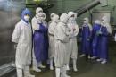 Employees stand during a seizure conducted at the Husi Food factory in Shanghai