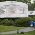 Golf fans walks past a leaderboard as play after play was suspended because of the weather during the second round of the Memorial golf tournament Friday, May 31, 2013, in Dublin, Ohio. (AP Photo/Darron Cummings)