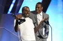 Kanye West and Jay-Z embrace as they accept the award for best group at the 2012 BET Awards in Los Angeles