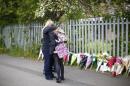A pupil is comforted outside Corpus Christi Catholic College where teacher Anne Maguire was fatally stabbed in Leeds, northern England