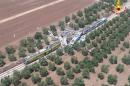 Two passenger trains are seen after a collision in the middle of an olive grove in the southern village of Corato