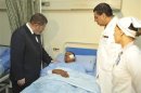 Egyptian President Mohamed Mursi talks with a soldier injured in a train accident at a hospital in Cairo
