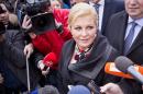 Conservative candidate Kolinda Grabar Kitarovic talks to the media outside a polling station in Zagreb, Croatia, Sunday, Jan. 11, 2015. A liberal incumbent and a conservative rival are heading into a surprisingly close showdown in Croatia's presidential runoff held amid deep discontent over economic woes in the European Union's newest member. (AP Photo/Darko Bandic)